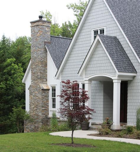 gray metal roof on gray house|dark grey brick house.